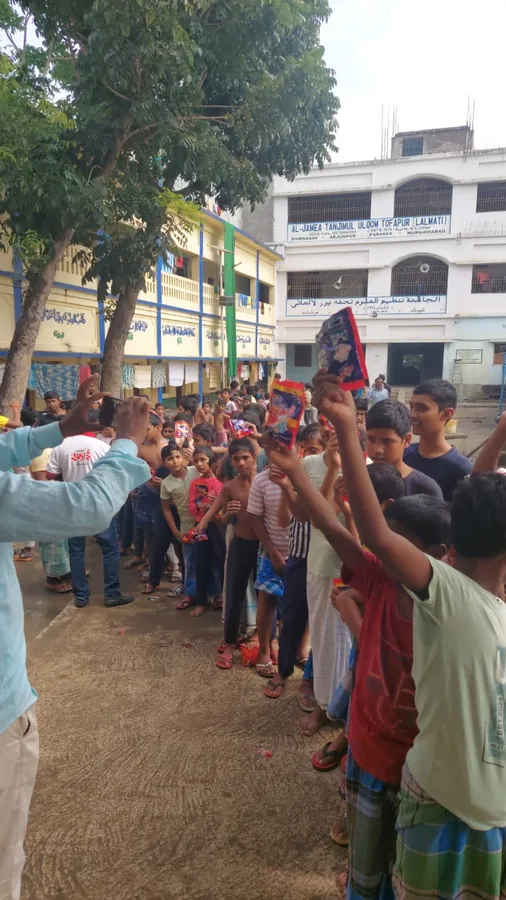 A line of children holding sample packs