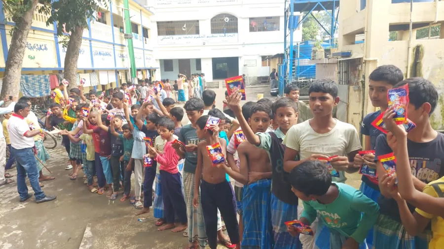 Children queueing with sample packs
